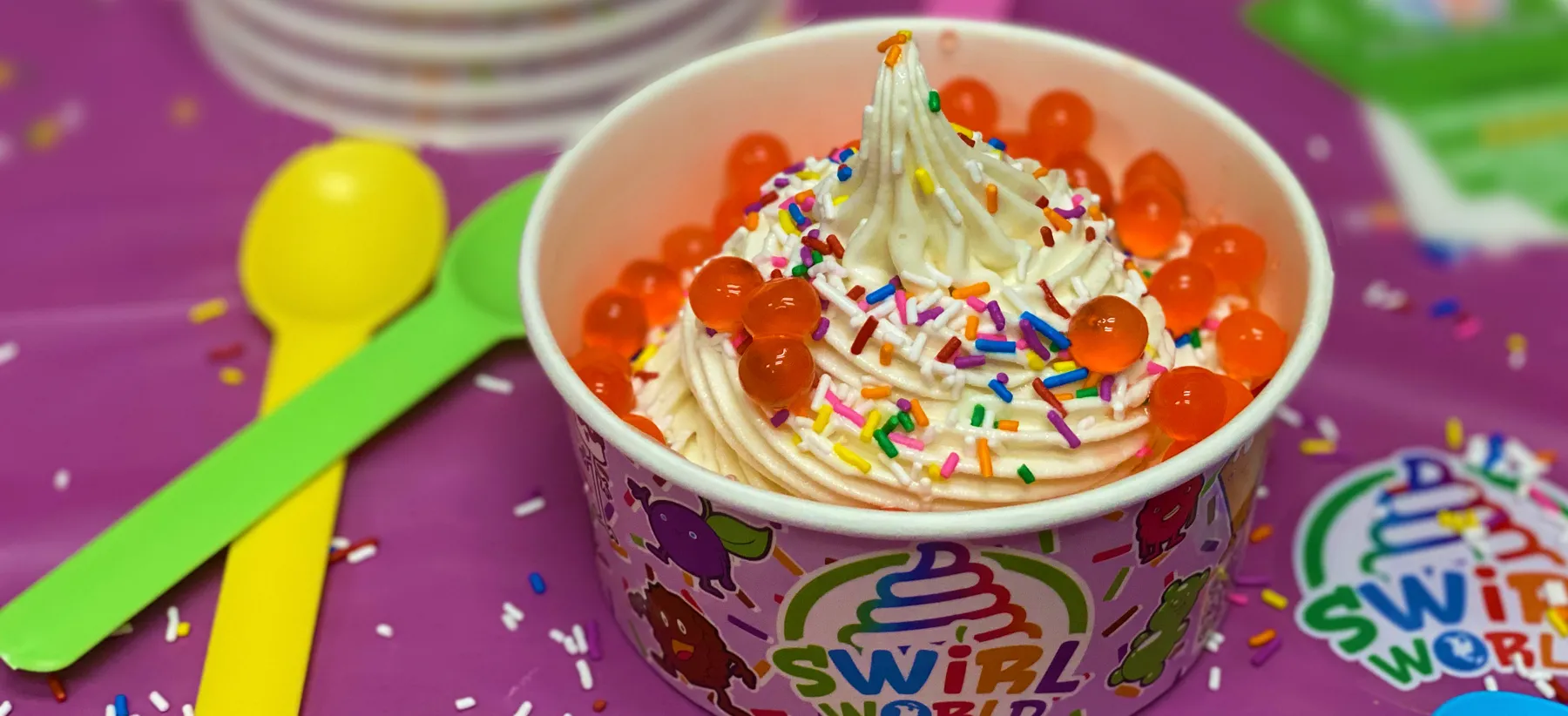 A Swirl World cup loaded with toppings — placeholder until the catering shoot