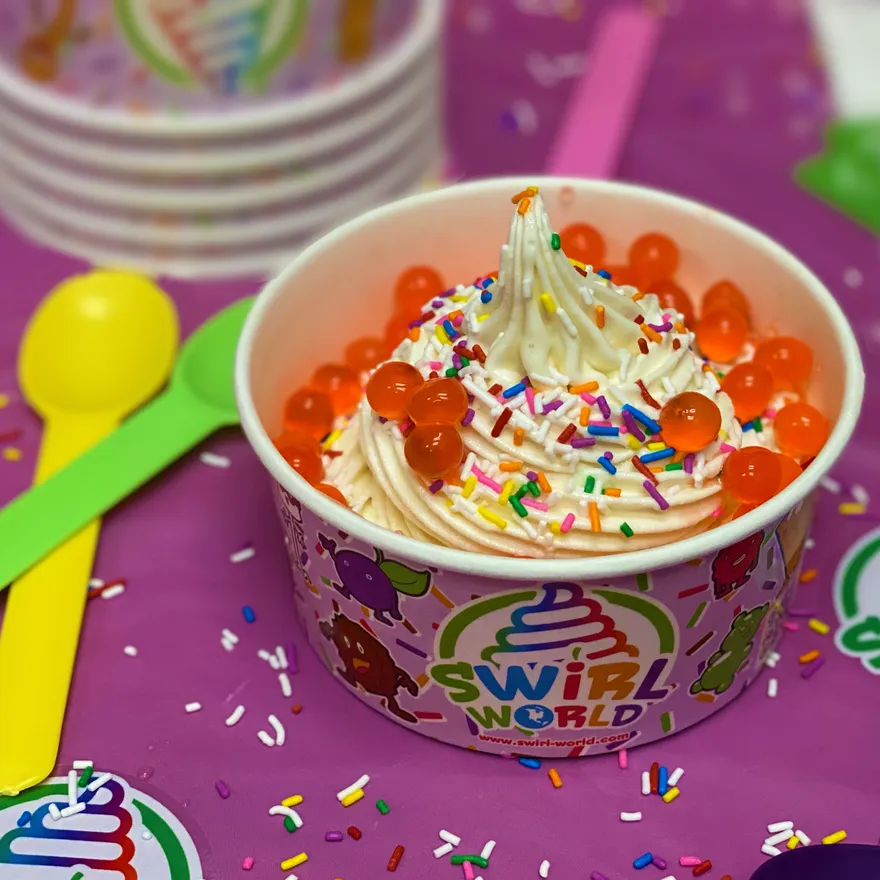 A spread of Swirl World cups and toppings
